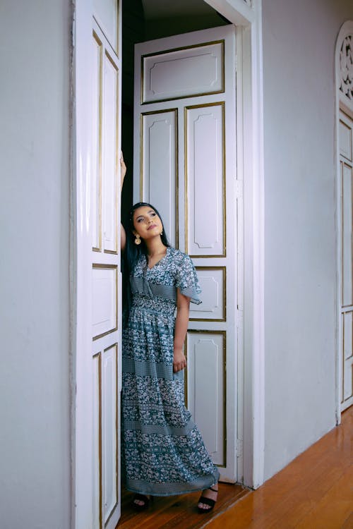 Young Woman Posing in a Blue Maxi Dress with a Pattern 