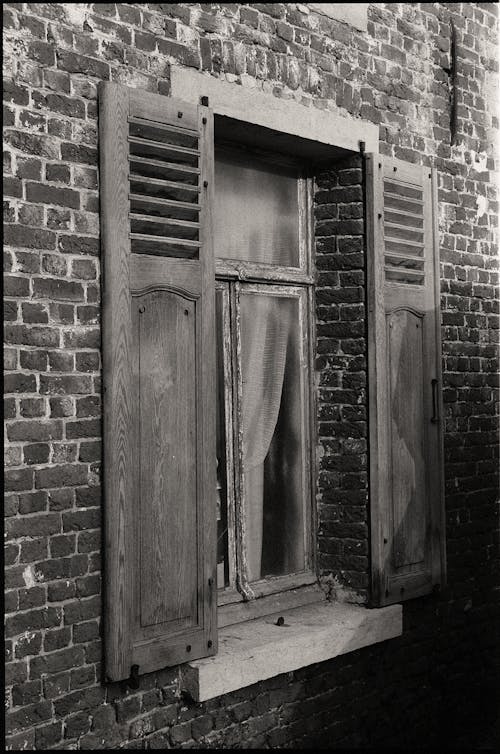 Free A Window with Wooden Shutters in a Brick Building  Stock Photo