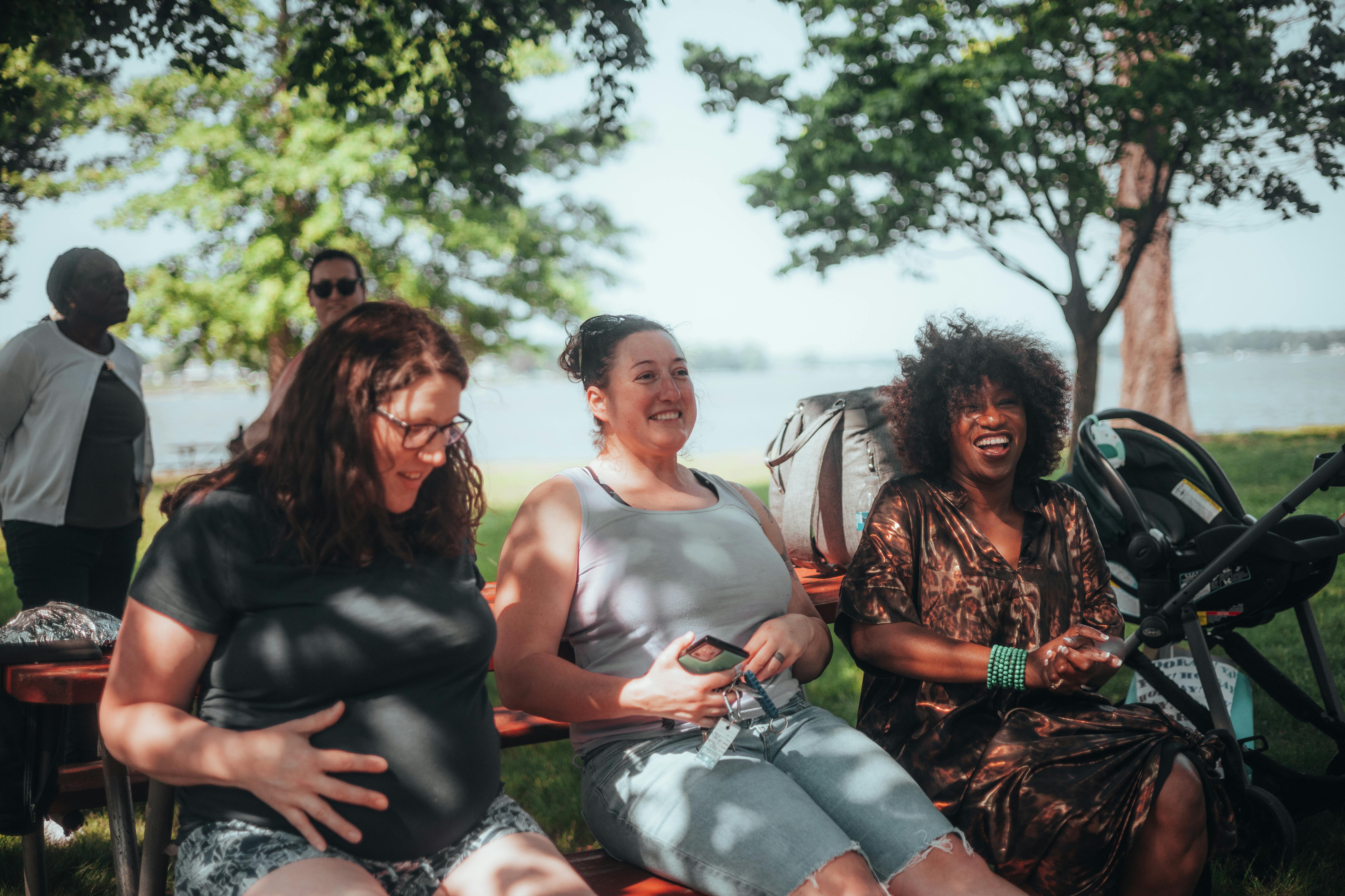 Mothers laughing together at a community event in Houston Texas