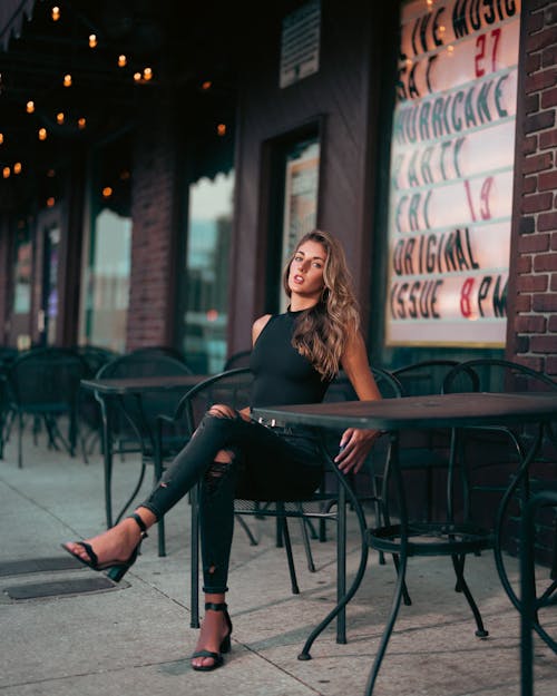 Woman Sitting at Cafe in Town