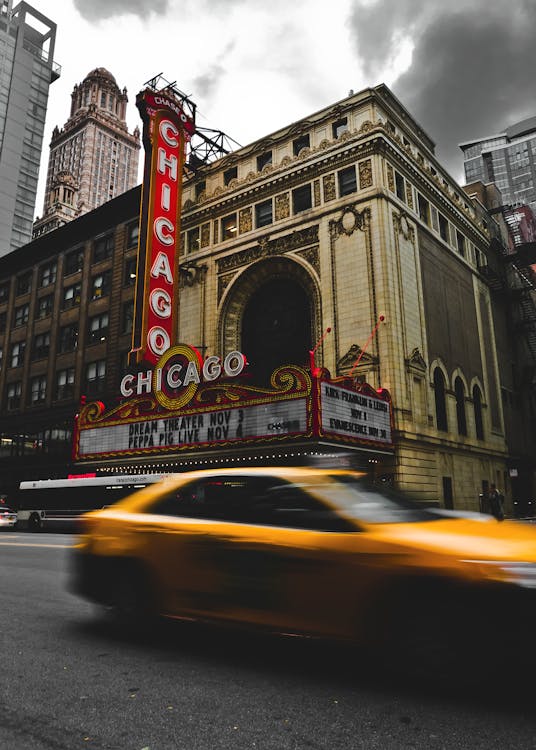 Free Passing Cars Near Chicago Theater Stock Photo