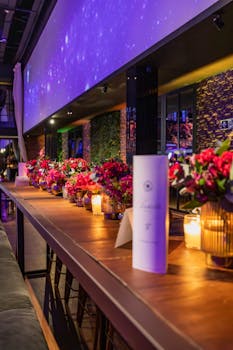 Luxurious dining setup with vibrant floral arrangements and ambient lighting, perfect for celebrations or events.