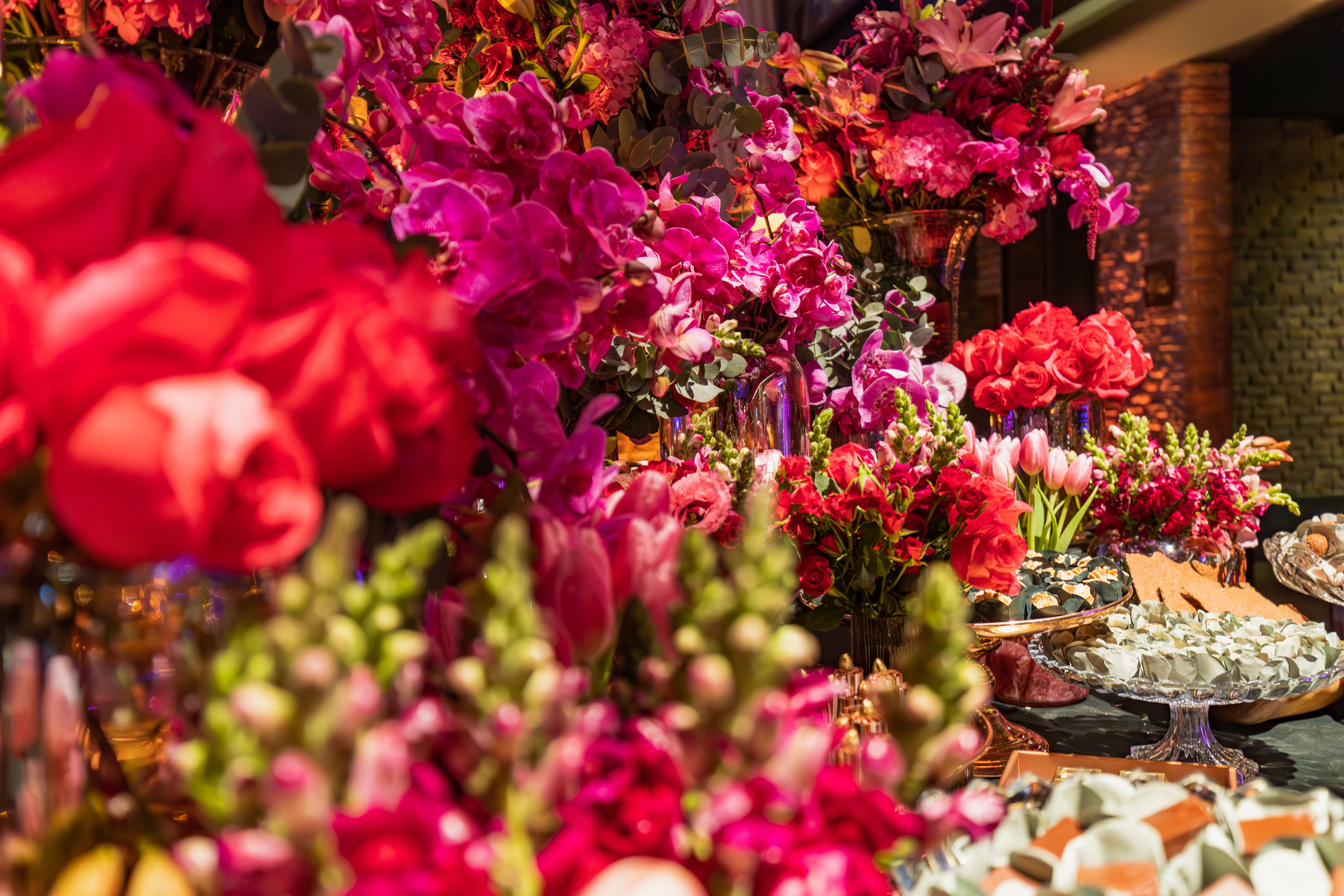 Vibrant display of flowers and sweets in an elegant indoor setting.