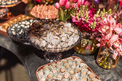 Free Luxurious dessert table with chocolates and vibrant flowers for an elegant celebration. Stock Photo