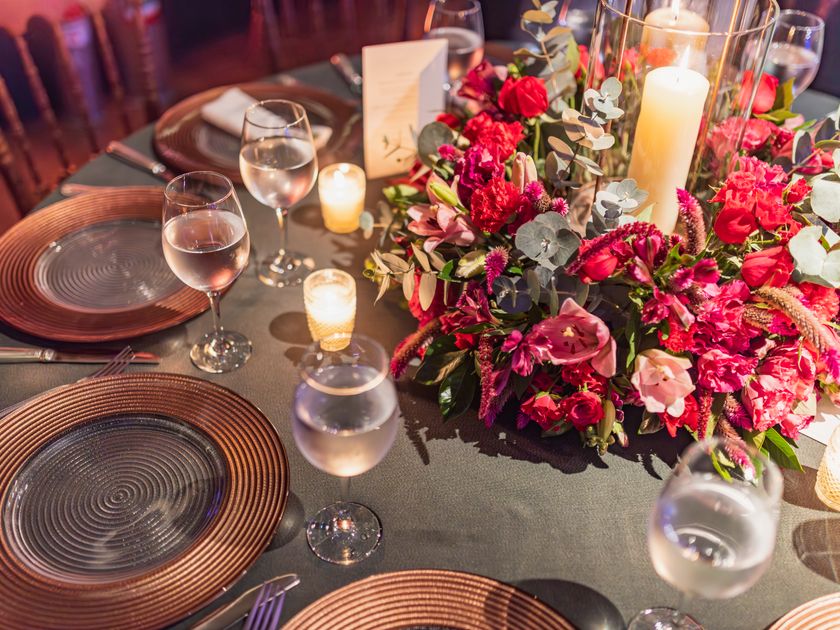 Round table dressed with a floral centrepiece and candles