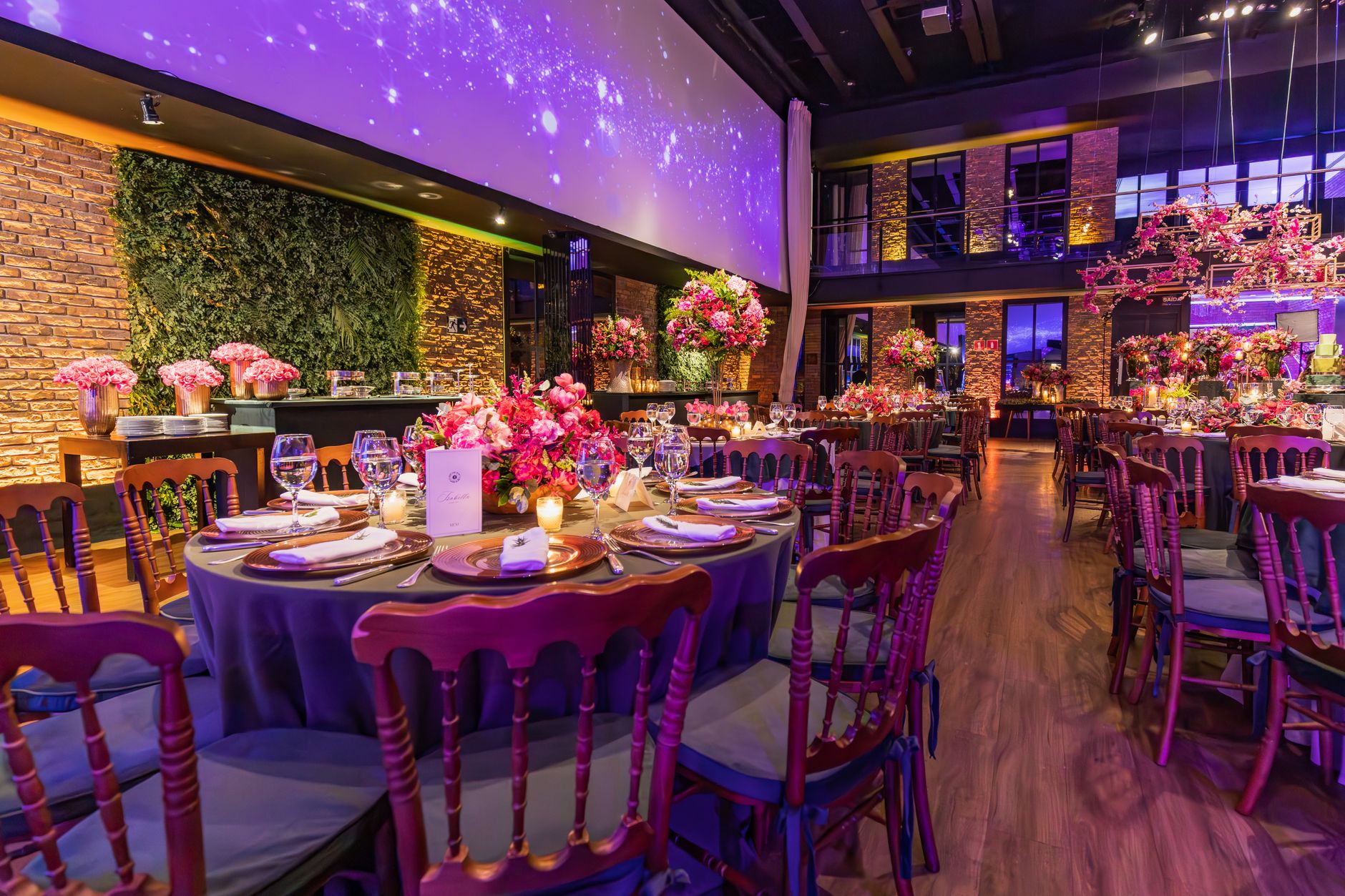 Luxurious indoor banquet setting with vibrant floral arrangements and elegant tableware for a spectacular celebration.