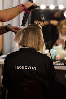 A stylist works on a model's hair backstage at a fashion show in Barcelona, Spain.