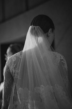 Black and white photo of a bride in a lace dress and veil at a wedding in Barcelona, Spain.