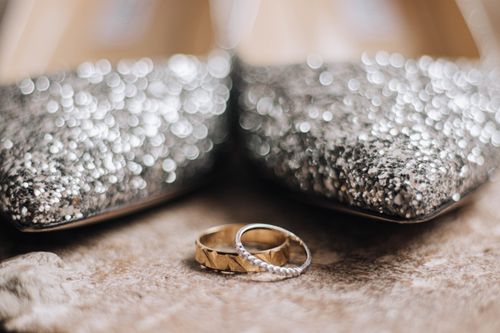 Free Close-up of gold and silver rings with sparkling silver shoes, highlighting luxury and elegance. Stock Photo