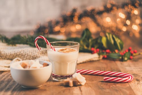 Clear Drinking Glass With Milk Near Candy Cane