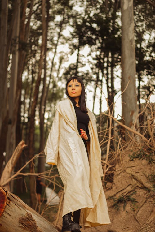 Woman in Coat Posing in Forest