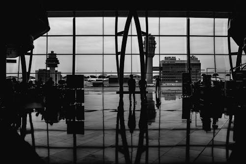 People Waiting in Terminal in Black and White