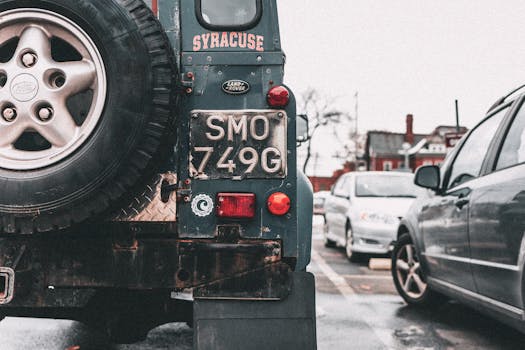 A classic Land Rover parked outdoors, showcasing vintage charm in an urban scene.