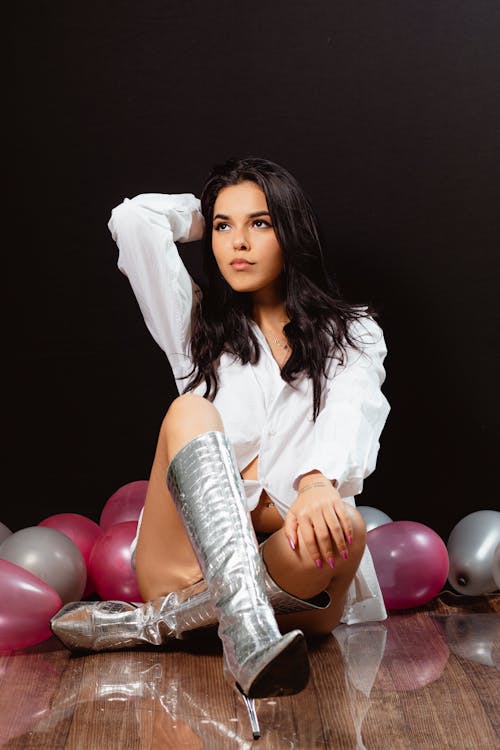 Woman Posing in Boots and White Shirt