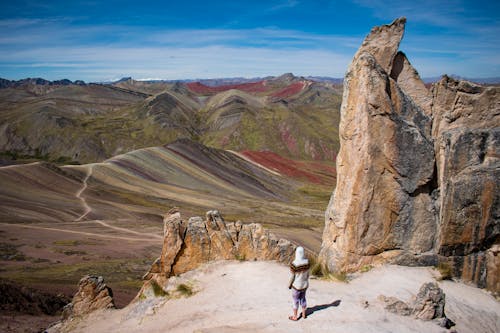 Person Standing among Arid, Barren Rocks