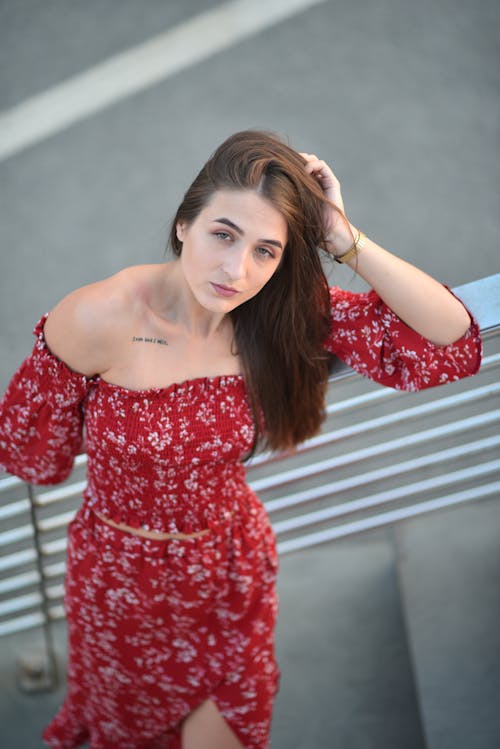 Woman in Red Dress Standing and Posing