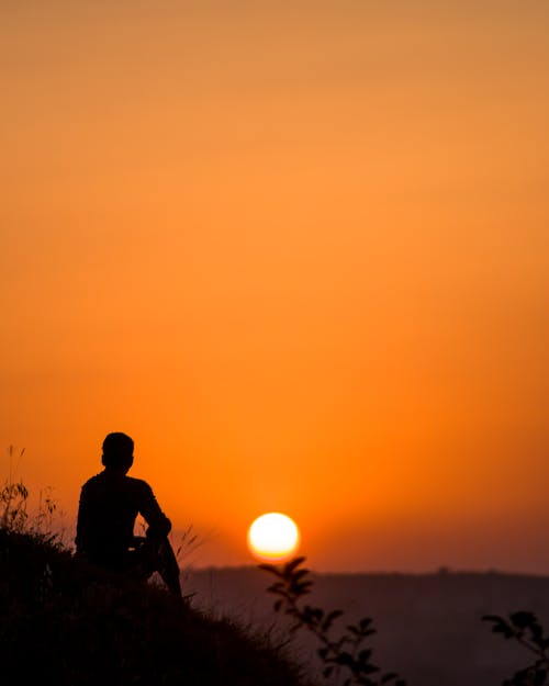 Silhouette of Sitting Person at Sunset