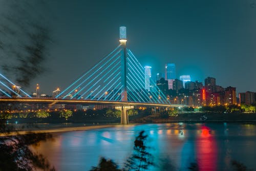 Illuminated Bridge in City at Night