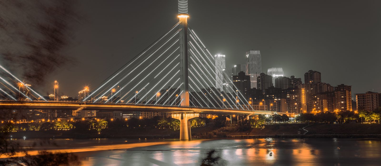 Captivating night view of a modern cable-stayed bridge in Nanning, Guangxi with city skyline. — flights from Hanoi to Nanning