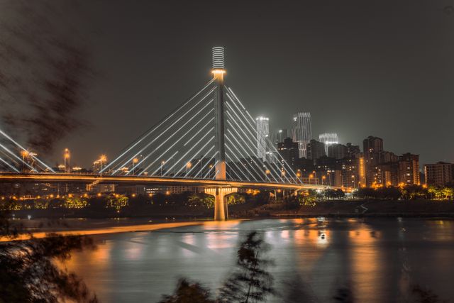 Captivating night view of a modern cable-stayed bridge in Nanning, Guangxi with city skyline.