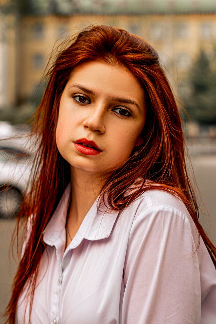 Portrait Of A Young Woman With Ginger Hair Standing Outside 