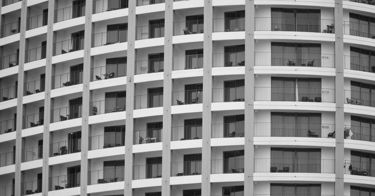 Black and white image of a modern apartment building facade with balconies in Nha Trang, Vietnam.