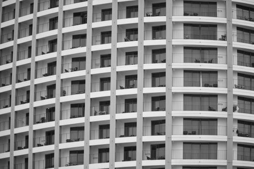 Free Black and white image of a modern apartment building facade with balconies in Nha Trang, Vietnam. Stock Photo
