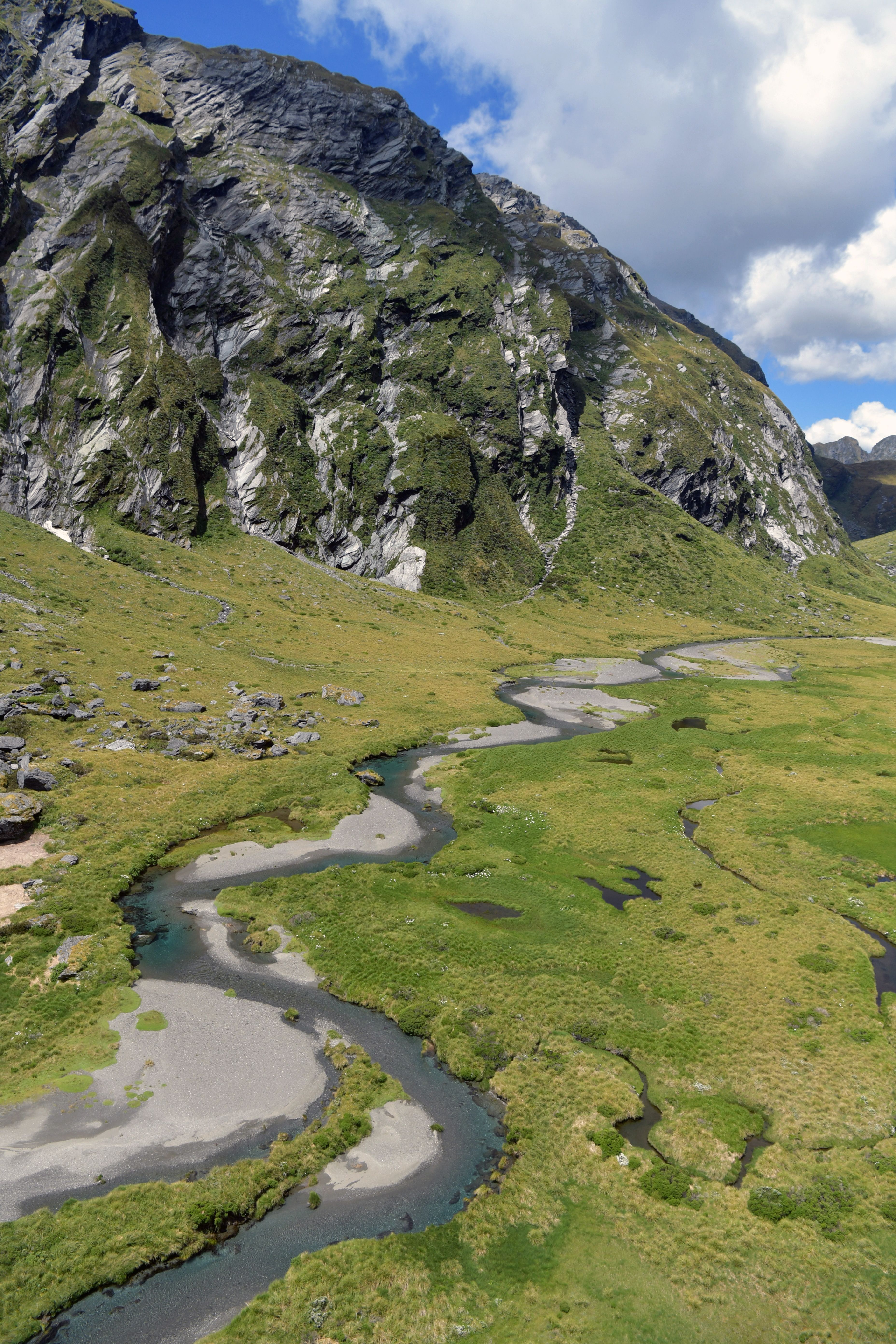 [ColoSach]-scenic-aerial-view-of-haast-mountain-range-with-winding-stream-in-west-coast,-new-zealand.