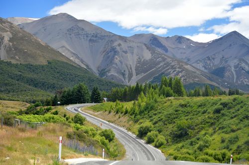 Free Breathtaking view of a winding road through the mountainous landscape of Castle Hill, New Zealand. Stock Photo