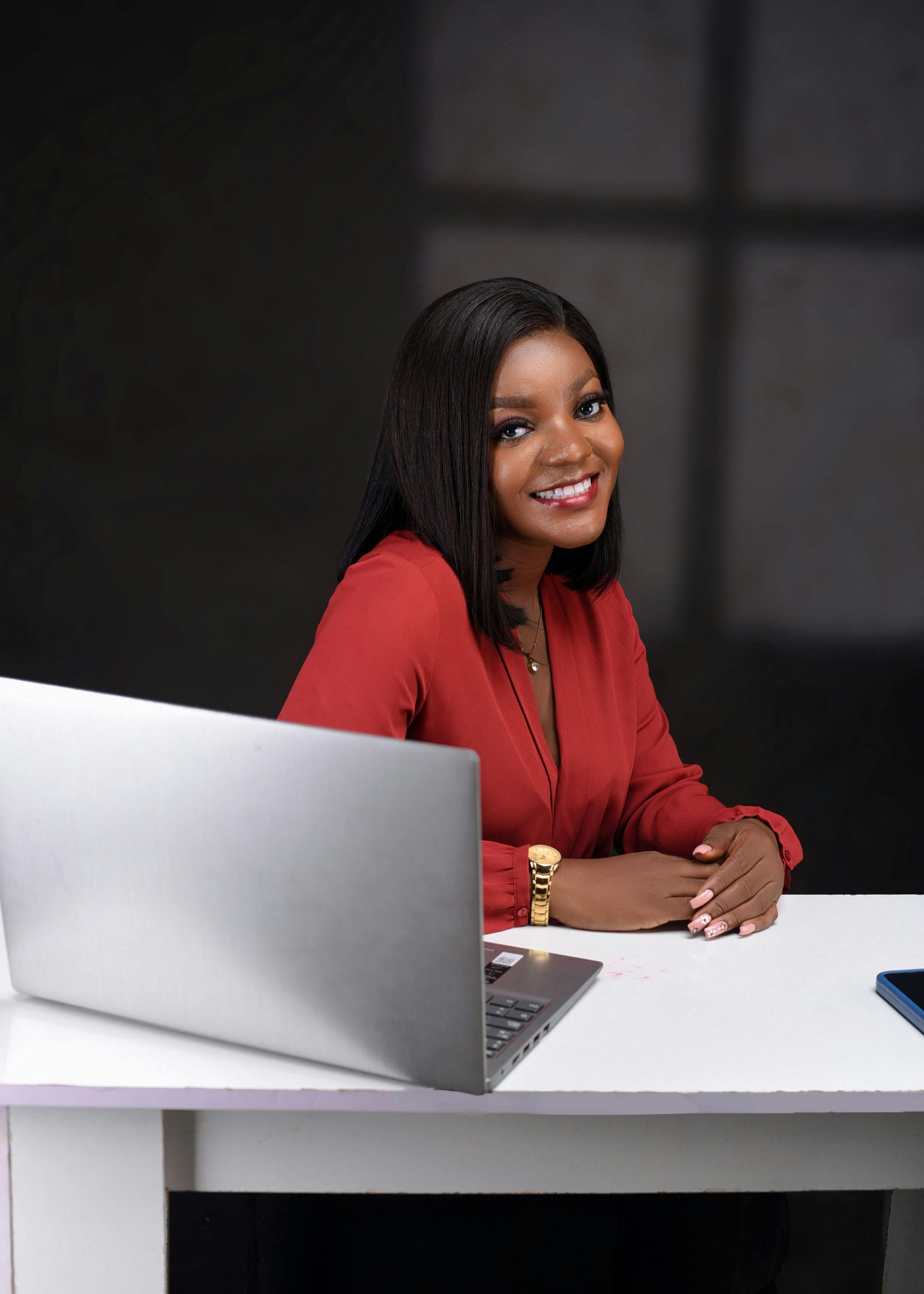 Free Photo Of Smiling Woman Sitting By Desk With Laptop