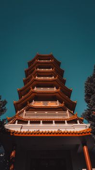 A stunning view of the Nan Tien Pagoda against a clear blue sky in Wollongong, NSW, Australia.