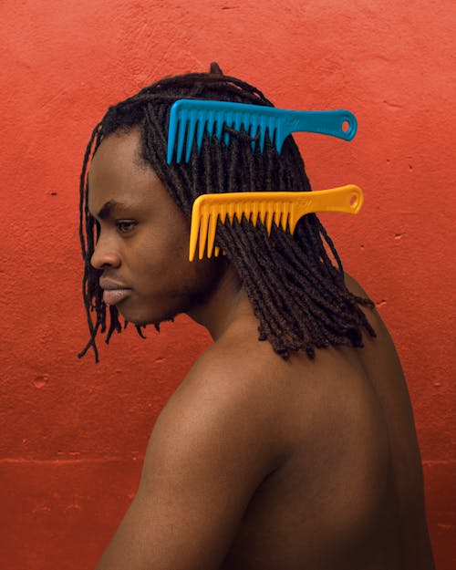 Shirtless Man with Combs in his Dreadlocks 