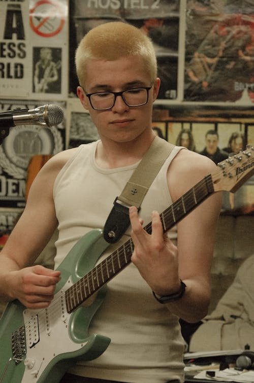 Man with Dyed, Blonde Hair Playing Electric Guitar