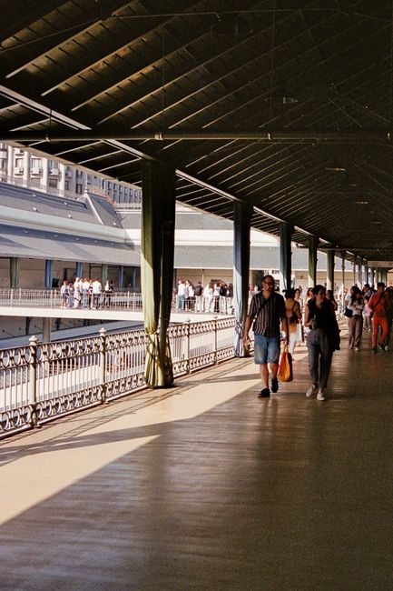 People walking in the Mercado do Bolhão, Porto, highlighting local architecture.