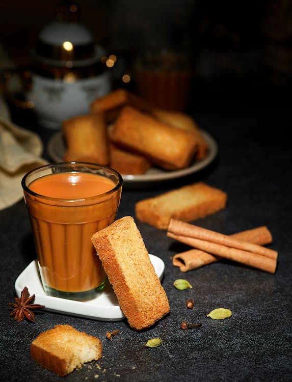 Free Glass of Masala Tea with Biscuits on a Table Stock Photo