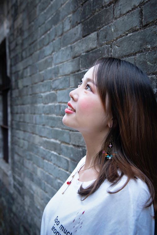 Free Woman Leaning on Black Wall Stock Photo