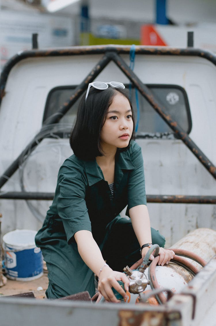 Young Woman Handling A Cylinder On The Pickup Truck 