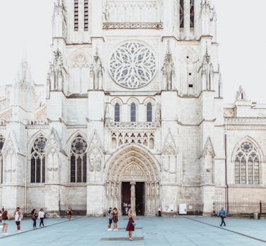 Stunning Gothic architecture of Bordeaux cathedral with people in view.