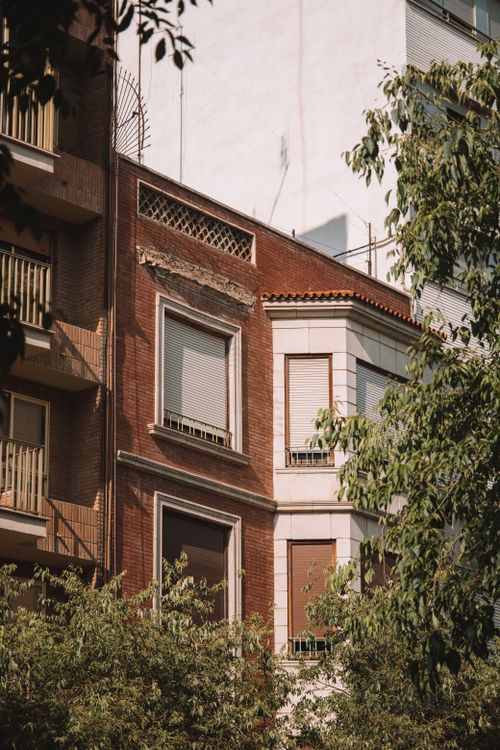 Free Sunlit building in Valencia, Spain surrounded by lush greenery and architectural details. Stock Photo
