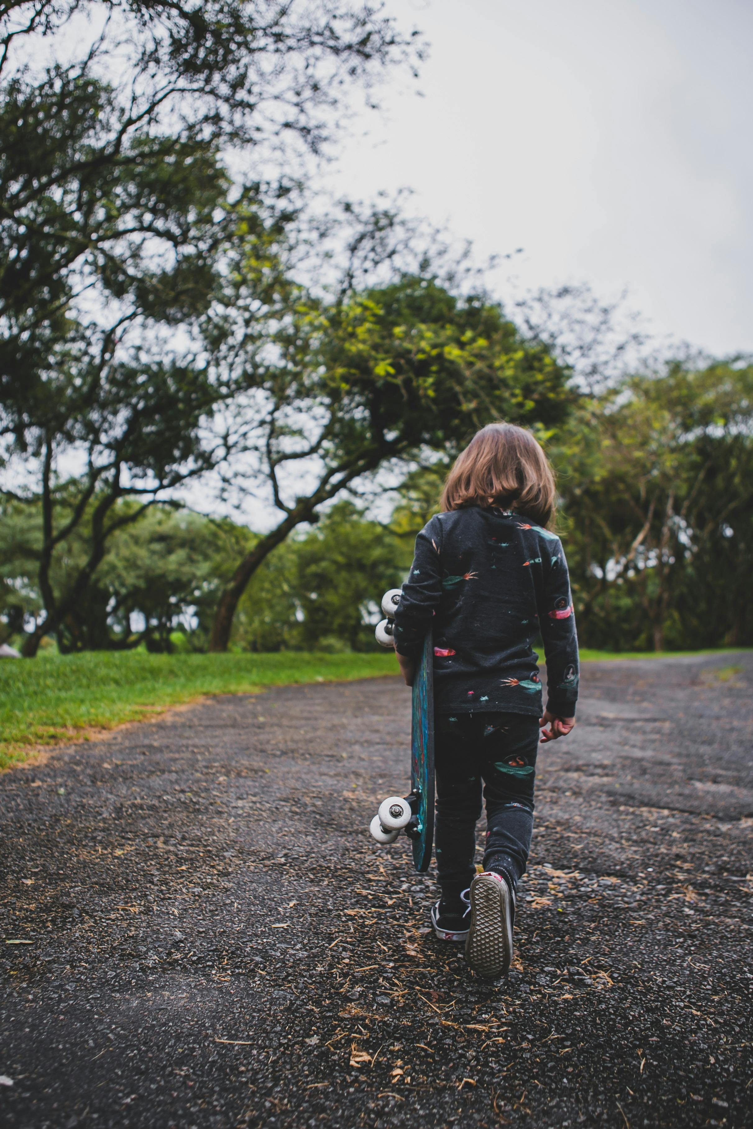 girl carrying skateboard