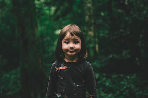 Cute Girl Posing in Green Forest