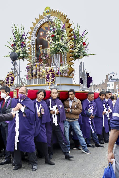 A Group of People Carrying a Religious Painting during a Procession 