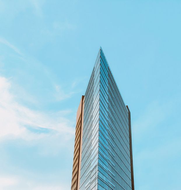 Contemporary skyscraper reaching into a bright blue sky, located in Berlin, Germany.