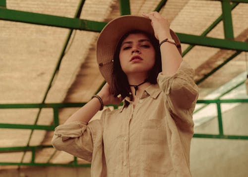 Low Angle View of Woman Wearing Straw Hat Standing in Garage