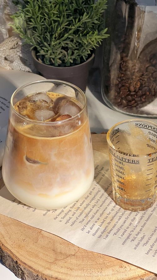 Free Chilled iced coffee served with a side of espresso in a sunny setting. Stock Photo