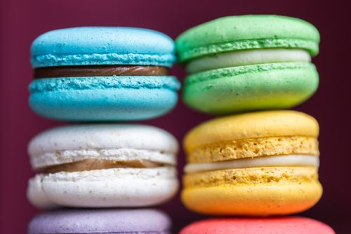 Free A vibrant close-up photo of colorful French macarons stacked together. Stock Photo