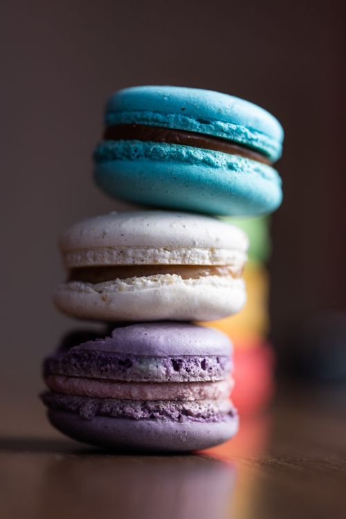 Free A close-up vertical shot of stacked colorful macarons, showcasing their vibrant hues and textures. Stock Photo