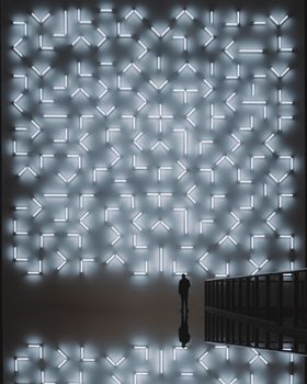 A man stands before a geometric light display in a Berlin art exhibition, creating a striking silhouette.
