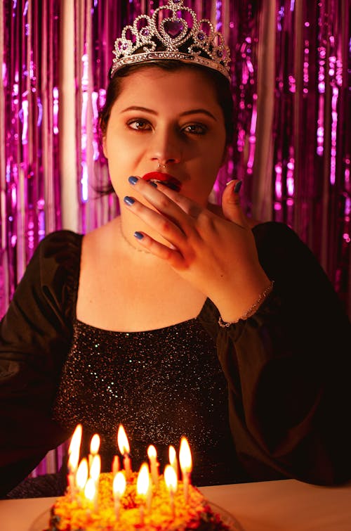 Woman in Crown Posing with Birthday Cake