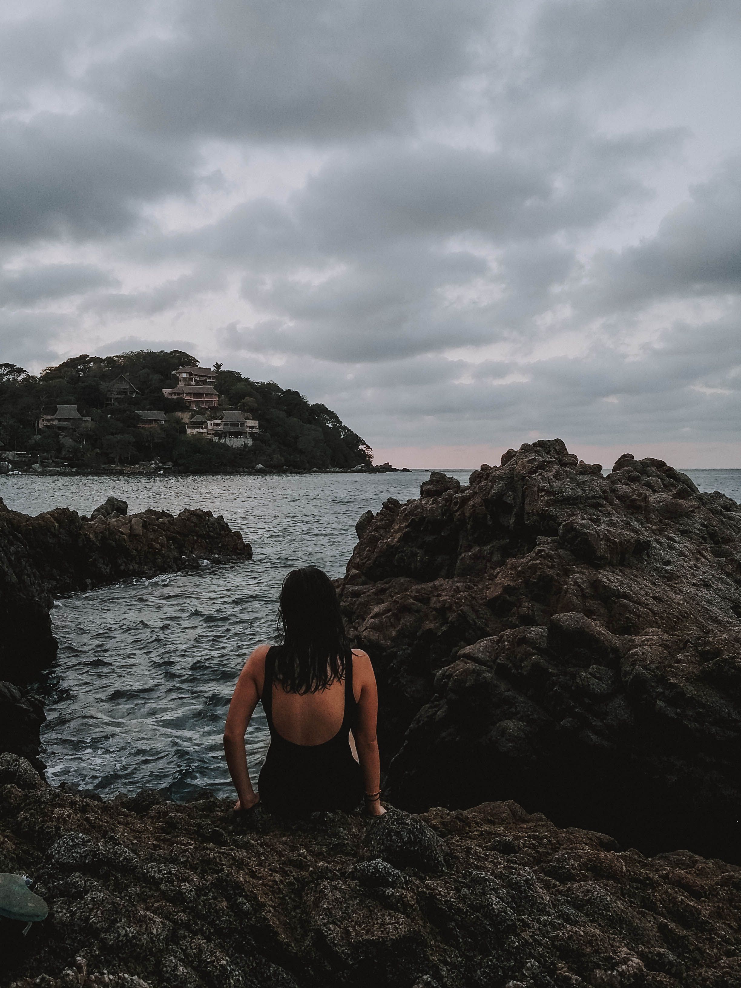 Photo of Woman Sitting on Rocks · Free Stock Photo